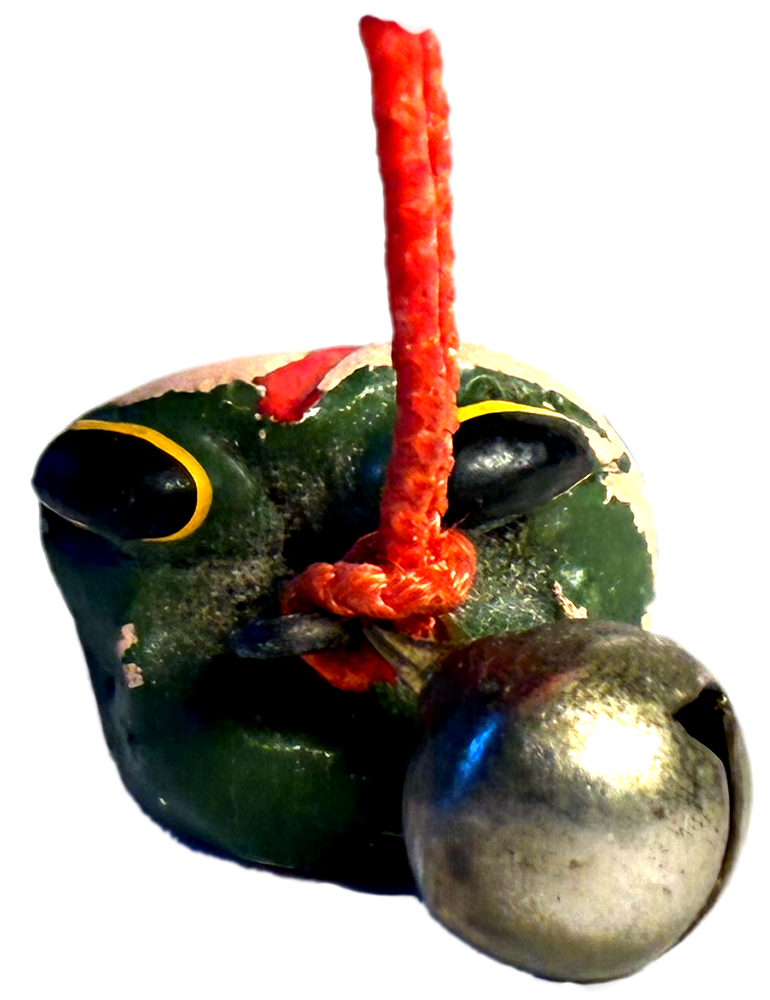 small wooden charm in the shape of the head of a frog