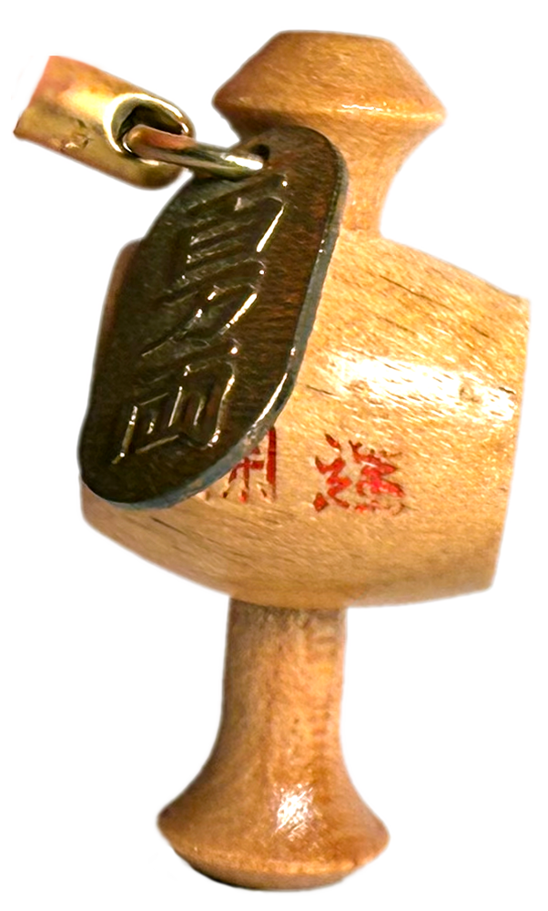 small wooden charm in the shape of a mallet